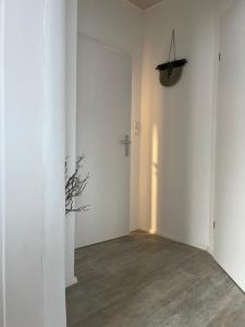 a room with white walls and a cross on the wall at Appartements Gabat Nähe Red Bull Ring in Sankt Michael in Obersteiermark