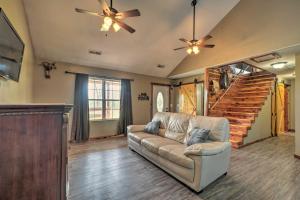 een woonkamer met een bank en een trap bij Private and Quiet Boone Terre Home with Fire Pit! in Bonne Terre