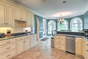 cocina grande con armarios blancos y paredes azules en Dock and Fire Pit Mt Gilead Villa on Lake Tillery, en Mount Gilead