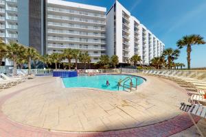 a swimming pool in front of a large building at Mainsail 334 in Destin