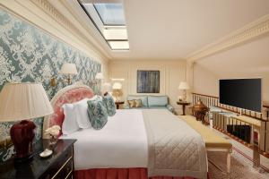 a hotel room with a large bed and a large window at Beau-Rivage Genève in Geneva