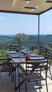 a wooden table and chairs on a patio with a view at Luxury stone house in a Nature park in Sali