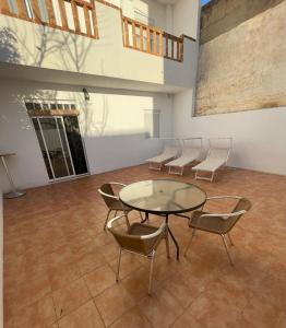 a room with a glass table and chairs in it at Precioso apartamento rural con patio in Caudete