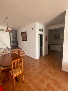 a dining room and living room with a table and chairs at Precioso apartamento rural con patio in Caudete