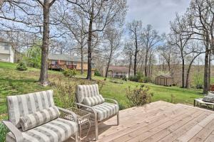 a couple of chairs and a table on a wooden deck at Less Than 1 Mi to Marina Family-Friendly Osage Beach Home in Osage Beach