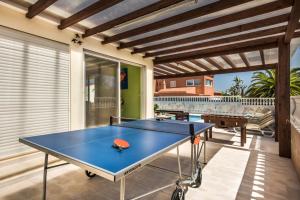 a ping pong table on the patio of a house at Carvoeiro Villa Miguel in Carvoeiro
