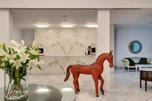 a wooden horse statue sitting on a table in a room at Barceló Teguise Beach - Adults Only in Costa Teguise