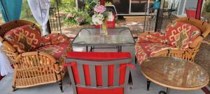 a group of chairs and a table with a glass table at Sleep Birds glamping trailer 5min to the beach in Nokomis