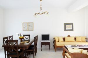 a living room with a couch and a table at Kedros Villas in Agios Prokopios