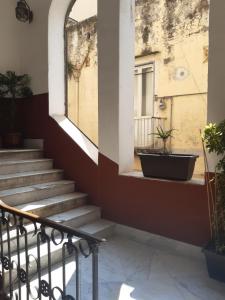 a set of stairs in a building with a window at La casa di FLO in Naples
