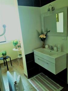 a bathroom with a sink and a mirror at B&B Mercedes in Bologna