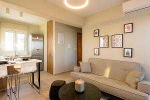 a living room with a couch and a table at Angelique Luxury apartment in Agios Nikolaos