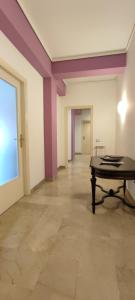 uma sala vazia com uma mesa e paredes roxas em Il gabbiano al Capo em Palermo