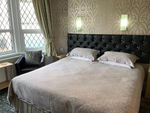 a bedroom with a large bed with two pillows at Myrtle house in Blackpool