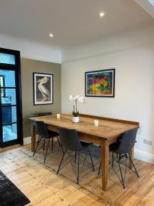 a dining room with a wooden table and chairs at Swn Y Don New Quay in New Quay
