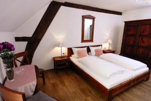 A bed or beds in a room at Hotel Klostermühle Siebenborn