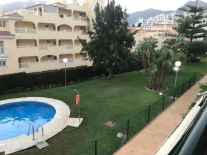 basen w ogrodzie obok dużego budynku w obiekcie Piso TORREQUEBRADA w mieście Benalmádena