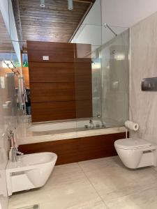 a bathroom with a tub and a toilet and a sink at #soloperte B&B apartments in Molfetta
