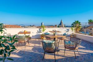 a patio with chairs and a table on a roof at Michel House in Nazareth +37 photos