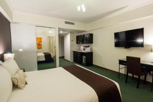 Postel nebo postele na pokoji v ubytování El Polo Apart Hotel & Suites