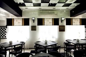 a dining room with tables and chairs and windows at MotelChuk in Ivano-Frankivsk