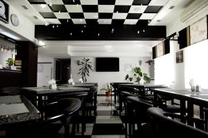 a restaurant with tables and chairs in a room at MotelChuk in Ivano-Frankivsk