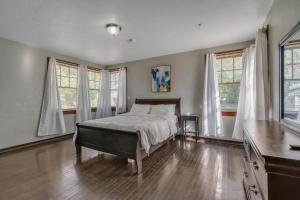 a bedroom with a bed in a room with windows at Comfy pet friendly home in Jacksonville mins to downtown’s in Jacksonville