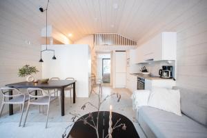 a living room and kitchen with a couch and a table at Villa Bruno in Syöte