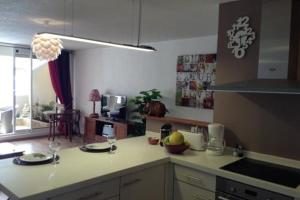 a kitchen with a counter top with two plates and glasses at Punauia Quiet apartment with sea view in Punaauia