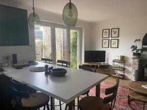 a dining room with a table and chairs and a television at Quality Court in Langton Matravers