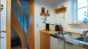 a kitchen with a sink and a stove top oven at FerienGut Dalwitz Kitzklause in Walkendorf