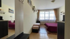 A bed or beds in a room at SUMMER BREEZE 406 Studio Sunny Beach
