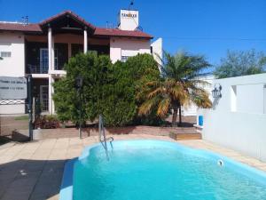 a swimming pool in front of a house at Renacer in Federación
