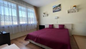 A bed or beds in a room at SUMMER BREEZE 406 Studio Sunny Beach