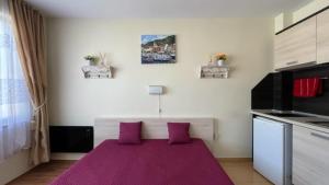 A bed or beds in a room at SUMMER BREEZE 406 Studio Sunny Beach