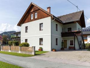 une maison blanche avec un toit marron dans l'établissement Vanek Apartment, à Mauthen