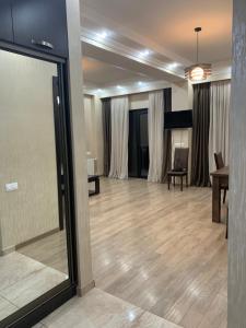 a large living room with a hard wood floor at APARTMENT IN THE NEW CITY in Tbilisi City
