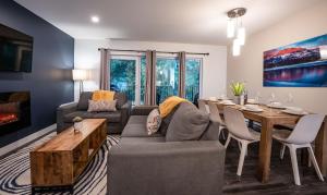 a living room with a couch and a table at Alpine Escape by Revelstoke Vacations in Revelstoke