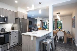 a kitchen with a counter and a dining room at Alpine Escape by Revelstoke Vacations in Revelstoke