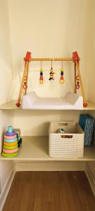 a shelf with some toys on it in a room at Kind -& diervriendelijk huisje in De Panne