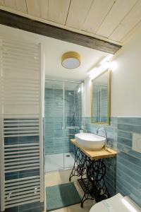 a bathroom with a sink and a shower at Aura in Banská Štiavnica