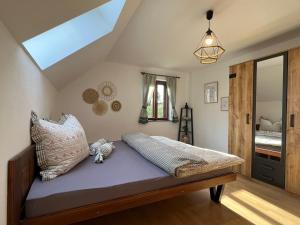 a bedroom with a bed with purple sheets and pillows at Chalupa U Dvořáků in Lomnice nad Lužnicí