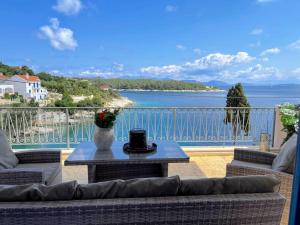 a balcony with a table and a view of the water at Paradise House apart3, 5min walking distance to Fiskardo center in Fiskardo
