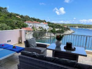 a balcony with furniture and a view of the water at Paradise House apart3, 5min walking distance to Fiskardo center in Fiskardo