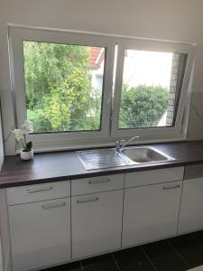 a kitchen with a sink and a window at AT-Rooms in Hannover +36 photos