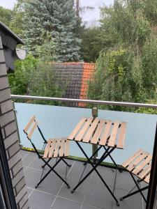 a picnic table and chair on a balcony at AT-Rooms in Hannover