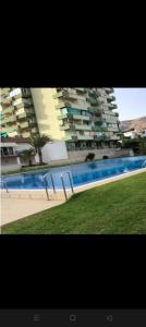 a large swimming pool in front of a building at El Paraiso in Aguadulce