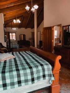 a bedroom with a bed with a checkered blanket at Villa paloma in Constanza