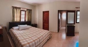 a bedroom with a bed with a checkered blanket at Villa paloma in Constanza