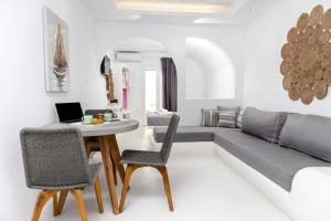 a living room with a couch and a table and chairs at Krina Mare Boutique Hotel in Naxos Chora